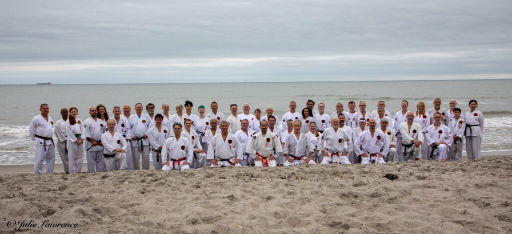 Over 50 karateka from Ueshiro Shorin-Ryu Karate gather for a group photo in front of the Atlantic Ocean in Cocoa Beach, FL.